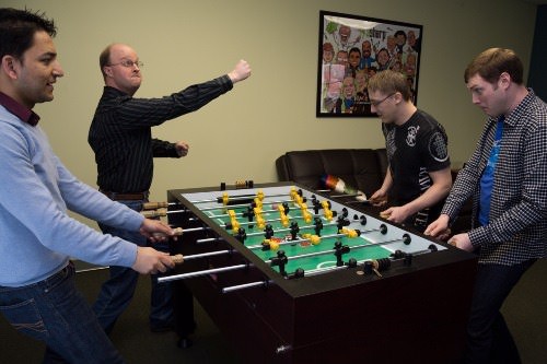 Playing Foosball with Freinds around a table