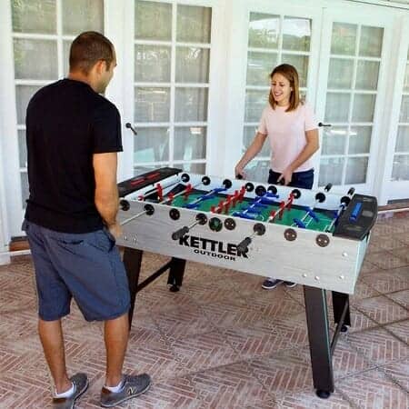 Young Couple Playing on  Kettler Foosball table