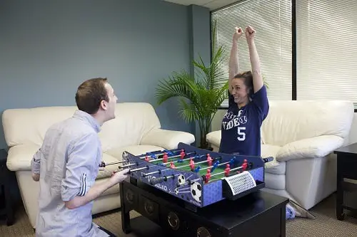 Young Couple Playing Foosball