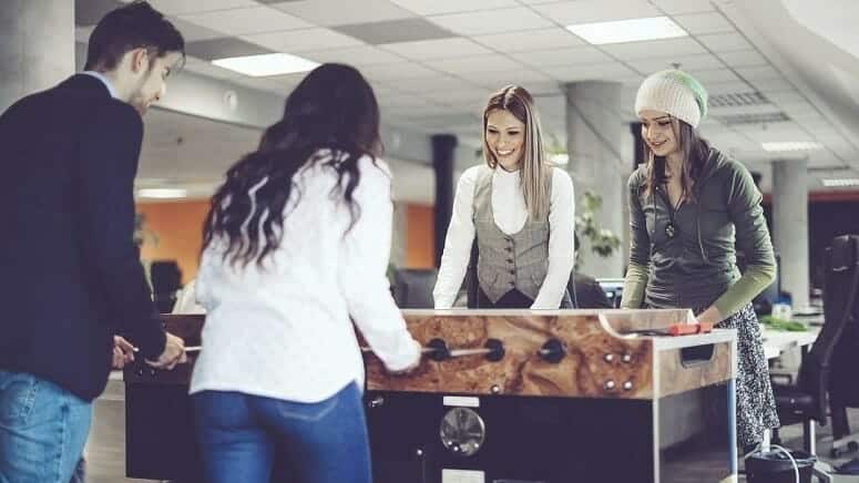 Millennials Playing Foosball At Office