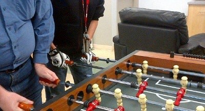 Man using foosball gloves.