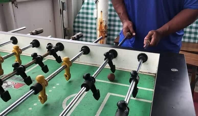 Playing Foosball On Old Table