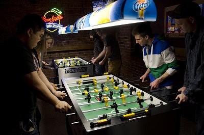 People playing foosball.