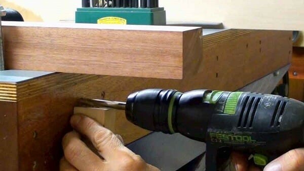 Using a drill to make a table.